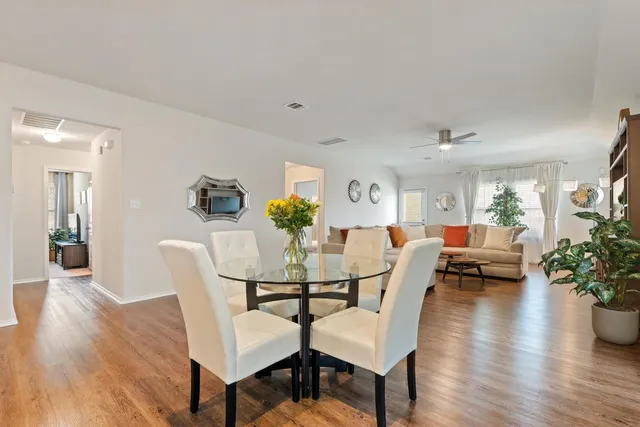 a view of a dining room with furniture and wooden floor