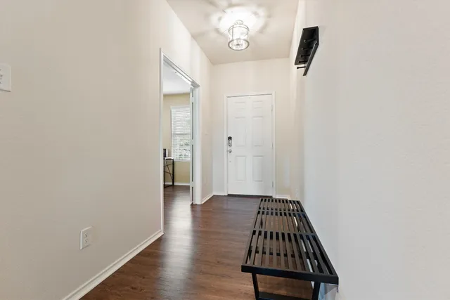 a view of a hallway with wooden floor