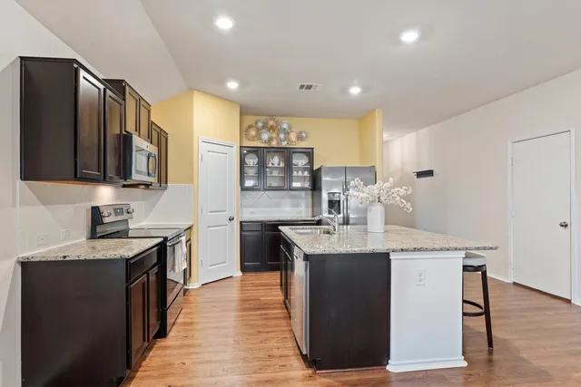 a living room with furniture and wooden floor