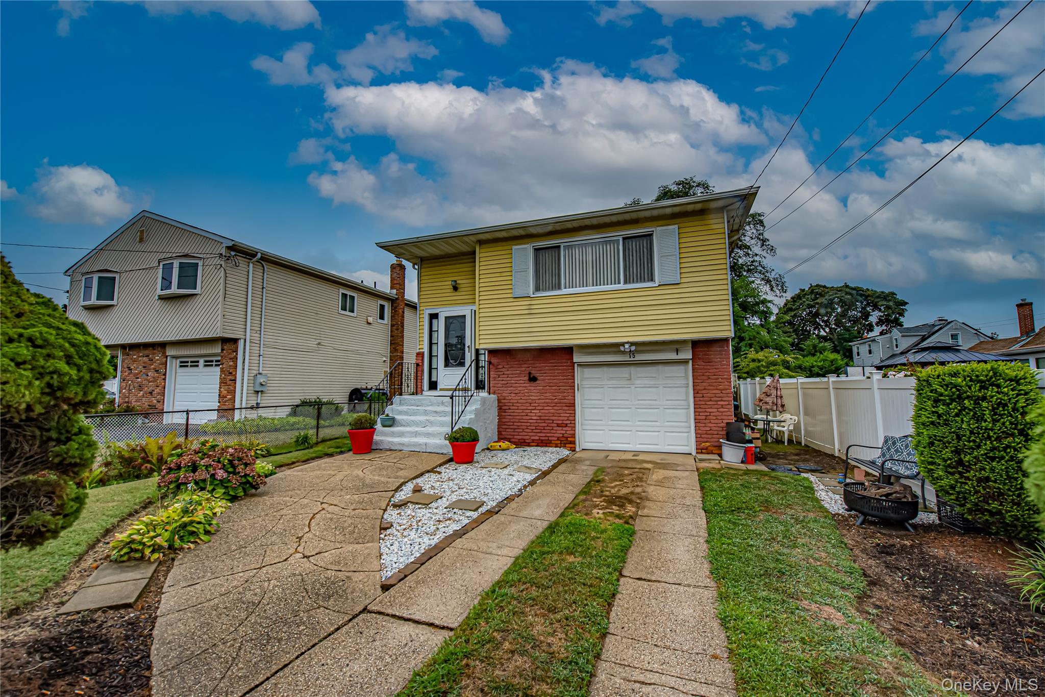 15 Major Road Massapequa, NY 11758 - Photo 2 of 25 a front view of a house with a yard and garage
