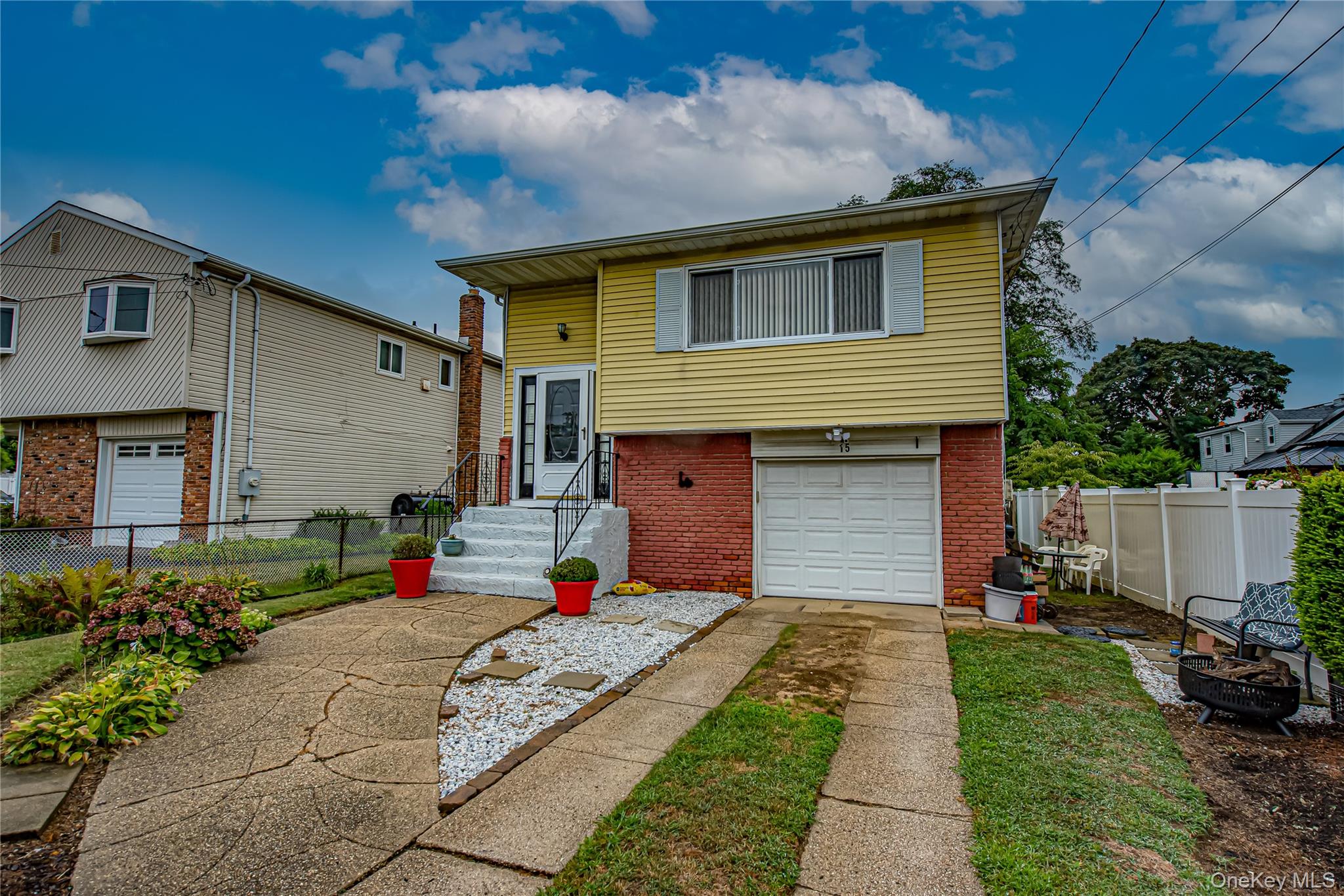 15 Major Road Massapequa, NY 11758 - Photo 24 of 25 a front view of a house with a yard and garage