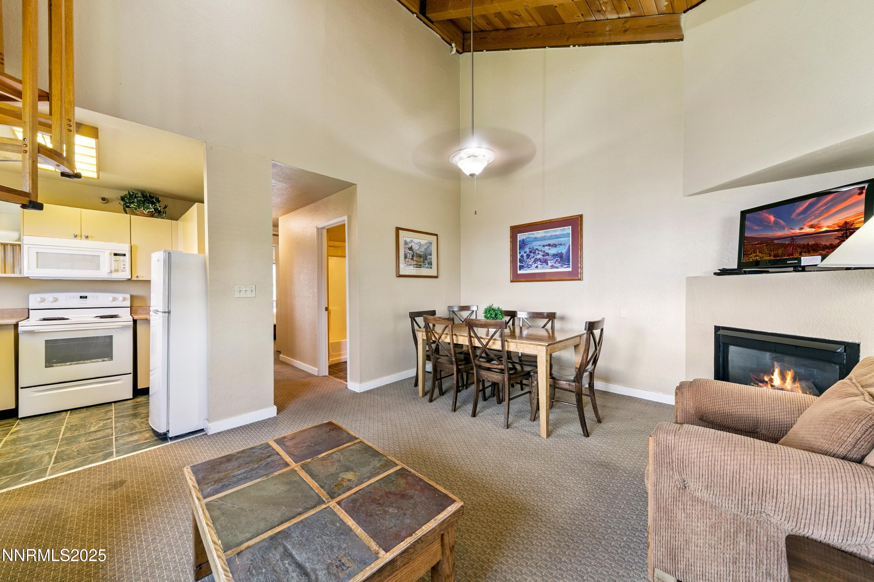 305 Galaxy Lane, Unit 7 Stateline, NV 89449 - Photo 15 of 61 a living room with furniture a dining table and a fireplace