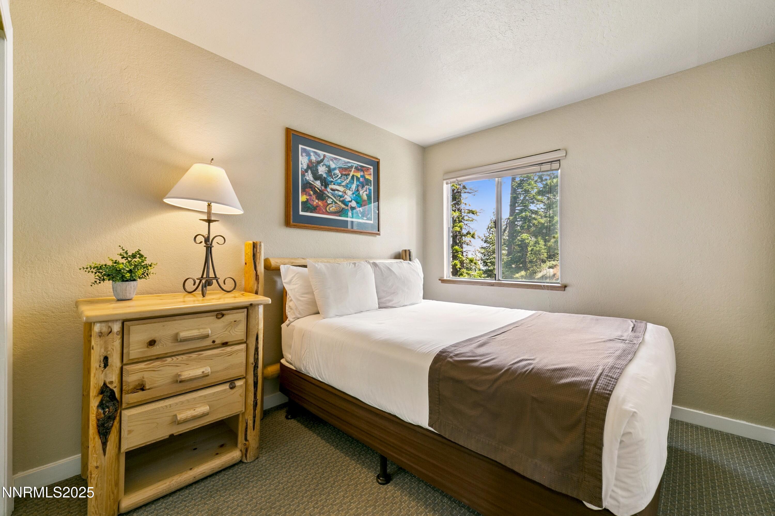 305 Galaxy Lane, Unit 7 Stateline, NV 89449 - Photo 17 of 61 a bedroom with a bed and a window