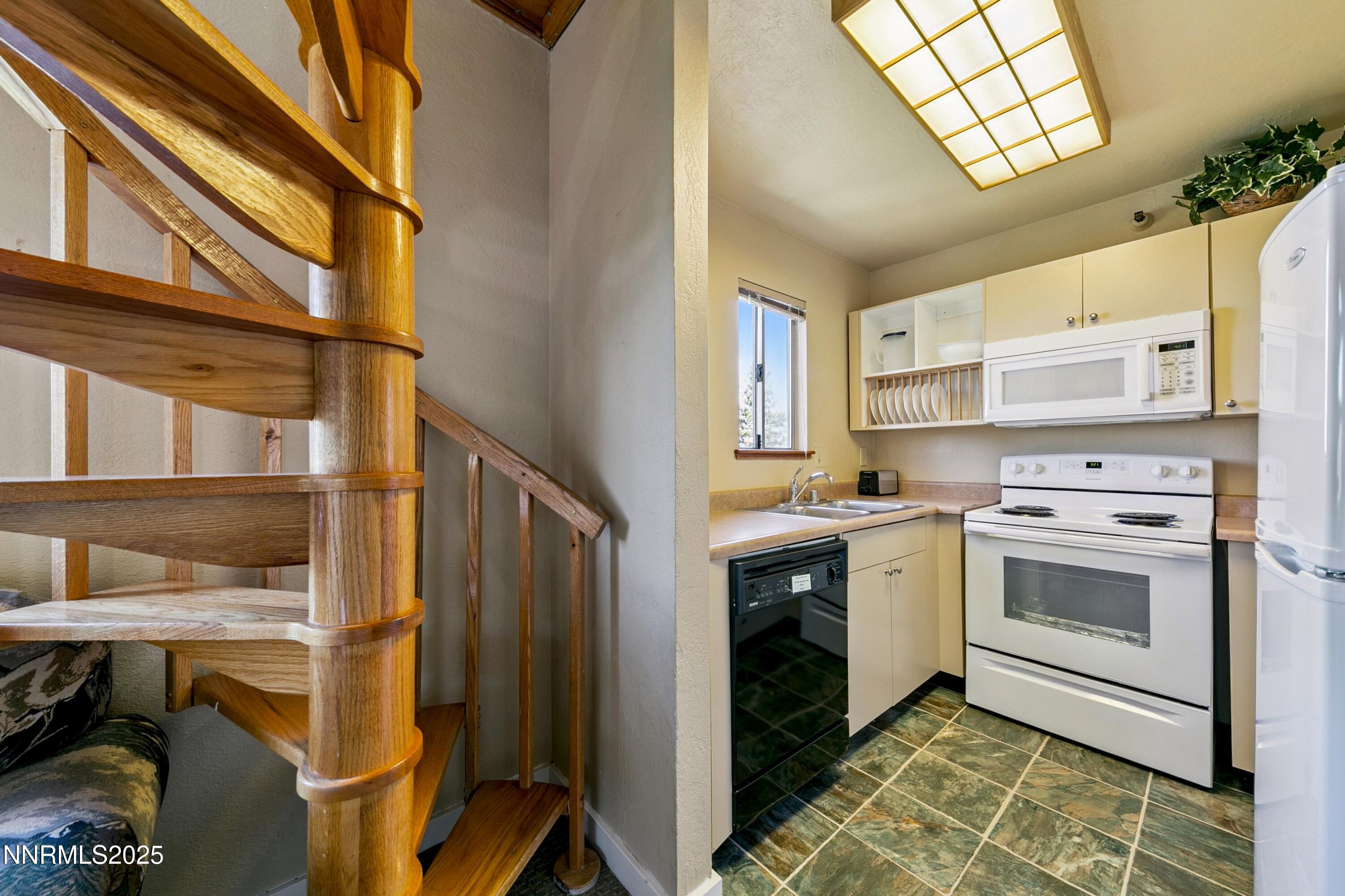 305 Galaxy Lane, Unit 7 Stateline, NV 89449 - Photo 20 of 61 a kitchen with a stove and white cabinets