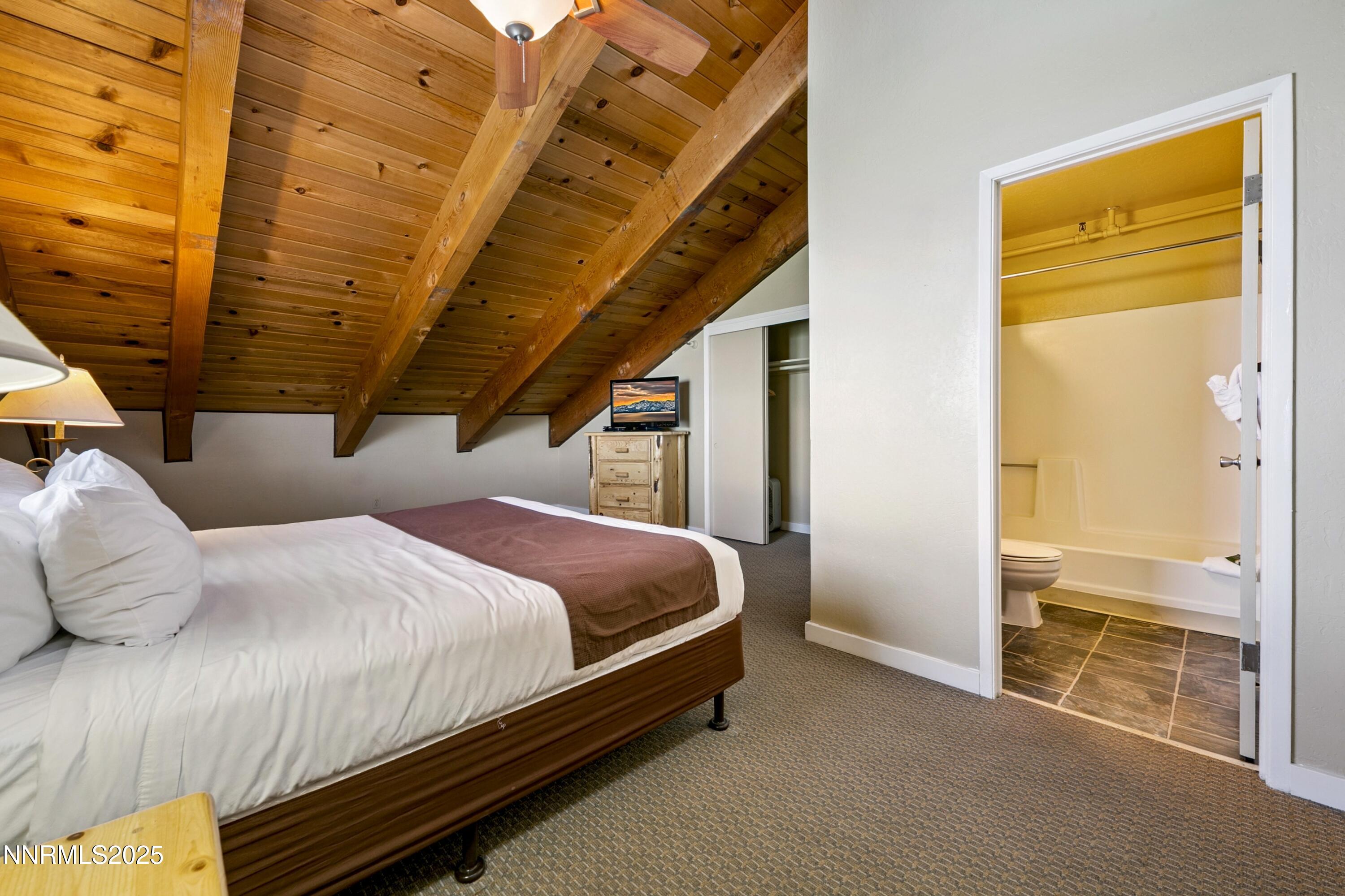 305 Galaxy Lane, Unit 7 Stateline, NV 89449 - Photo 21 of 61 a bedroom with a bed and wooden floor