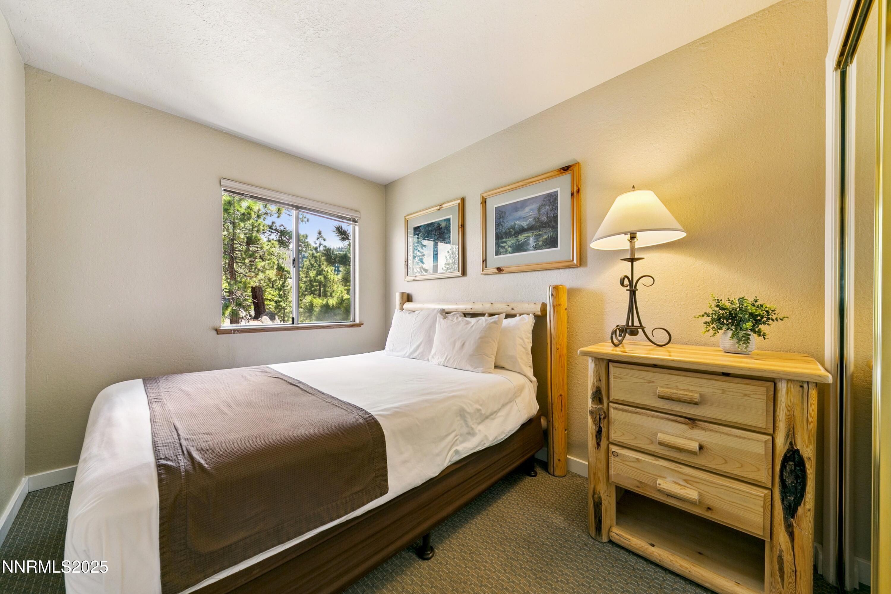 305 Galaxy Lane, Unit 7 Stateline, NV 89449 - Photo 5 of 61 a bedroom with a bed and a window