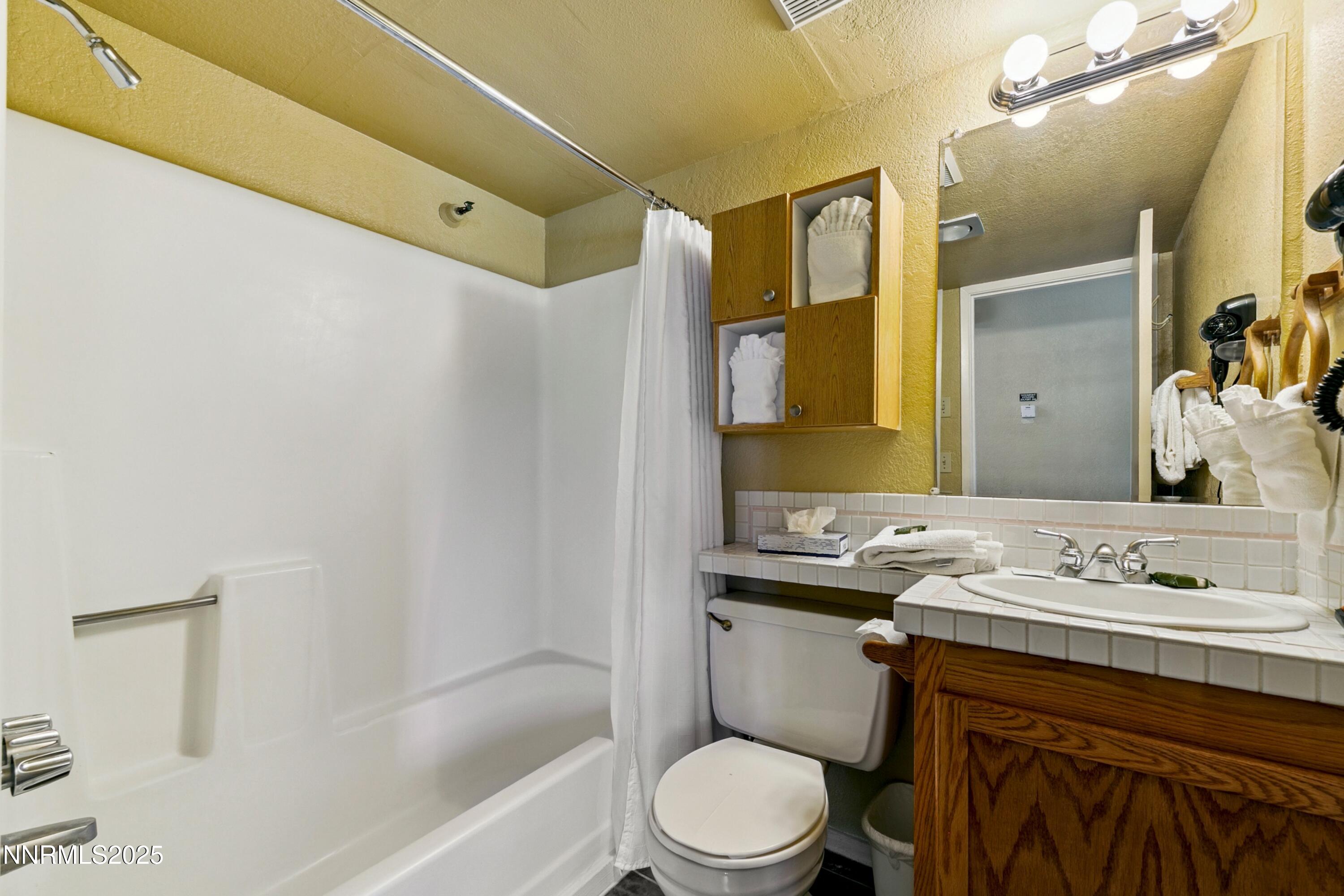 305 Galaxy Lane, Unit 7 Stateline, NV 89449 - Photo 6 of 61 a bathroom with a sink a toilet and shower