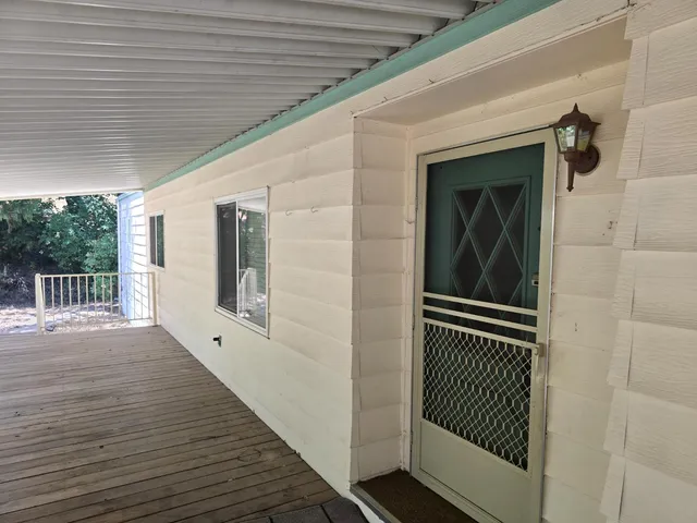 a view of a balcony with wooden floor