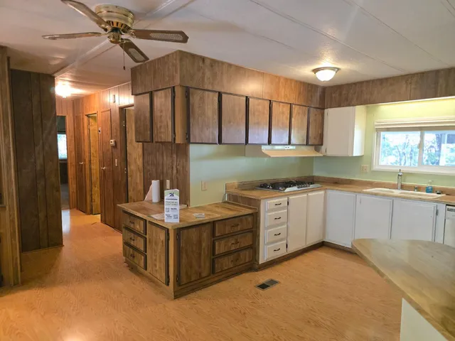 a kitchen with a sink cabinets and window