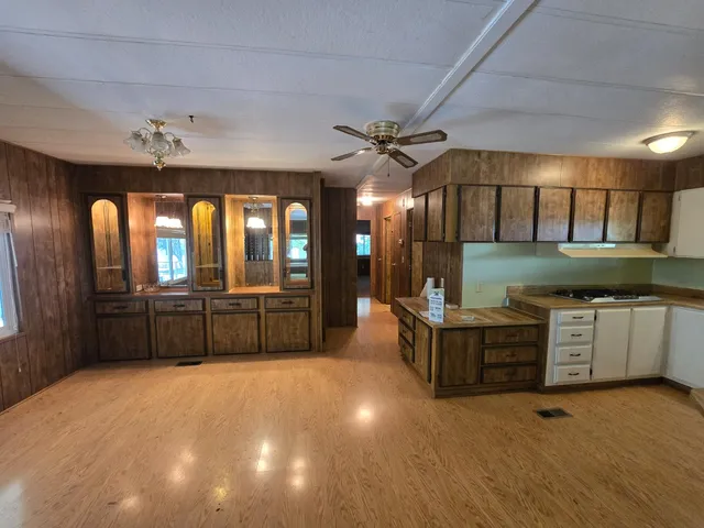 a kitchen with lots of counter space and windows