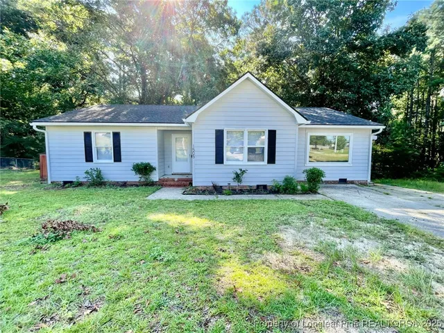 a front view of house with yard and green space