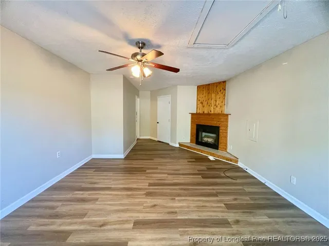 a view of empty room with a fireplace