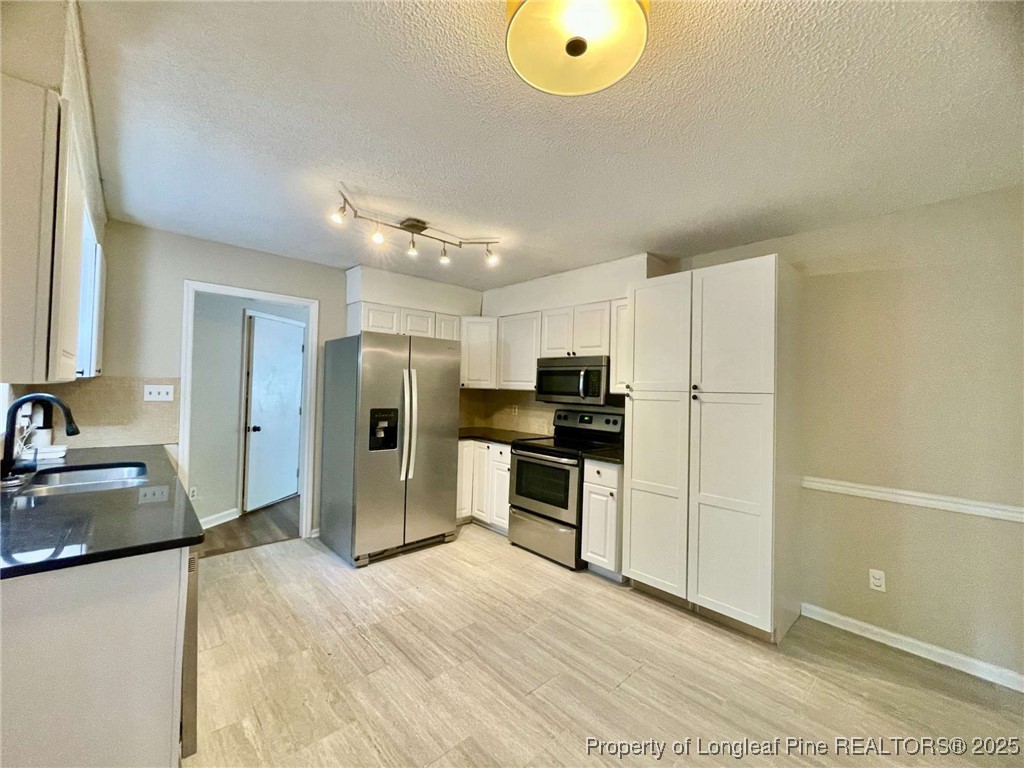 1505 Diamond Road Fayetteville, NC 28311 - Photo 13 of 21 a kitchen with a refrigerator and a sink