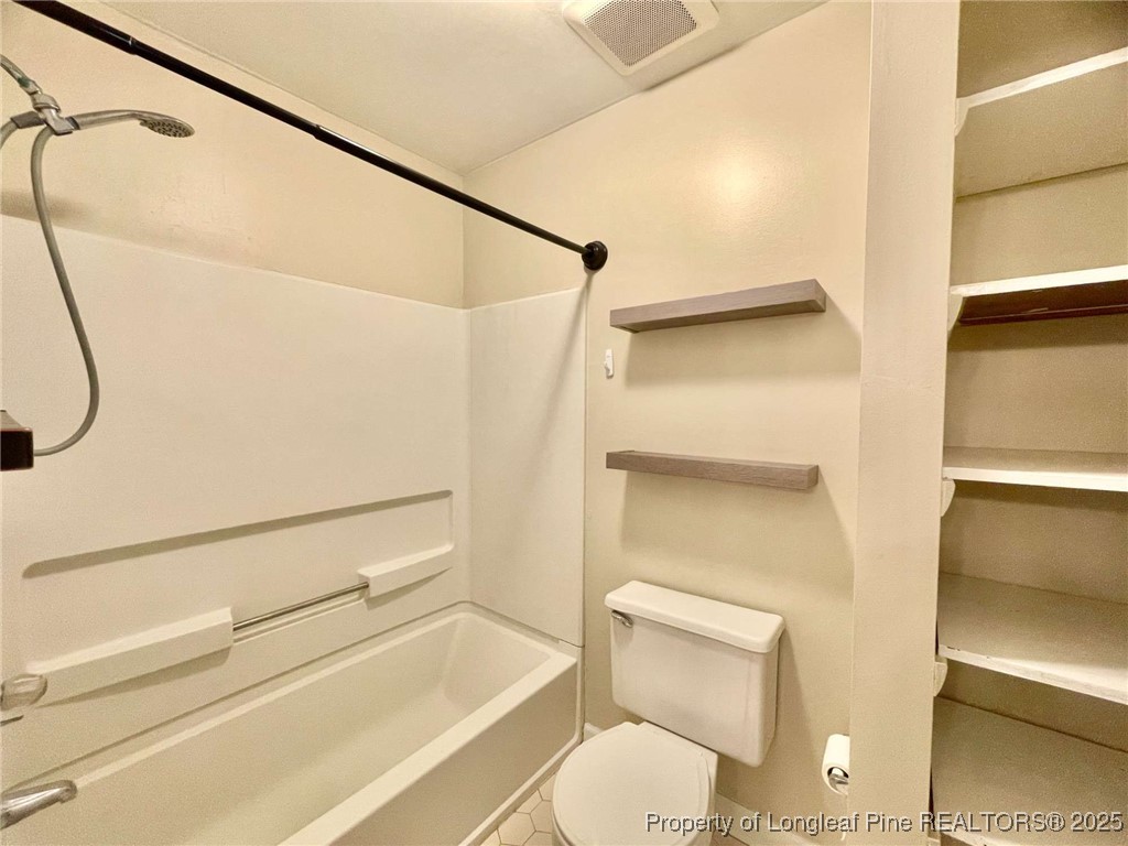 1505 Diamond Road Fayetteville, NC 28311 - Photo 16 of 21 a bathroom with a toilet and a shower