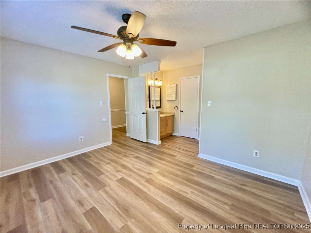 1505 Diamond Road Fayetteville, NC 28311 - Photo 18 of 21 a view of empty room with wooden floor and fan