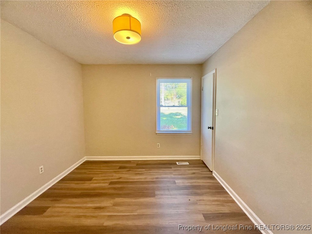1505 Diamond Road Fayetteville, NC 28311 - Photo 4 of 21 a view of room with window and wooden floor