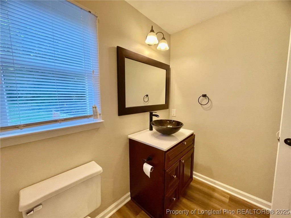 1505 Diamond Road Fayetteville, NC 28311 - Photo 5 of 21 a bathroom with a sink a mirror and vanity