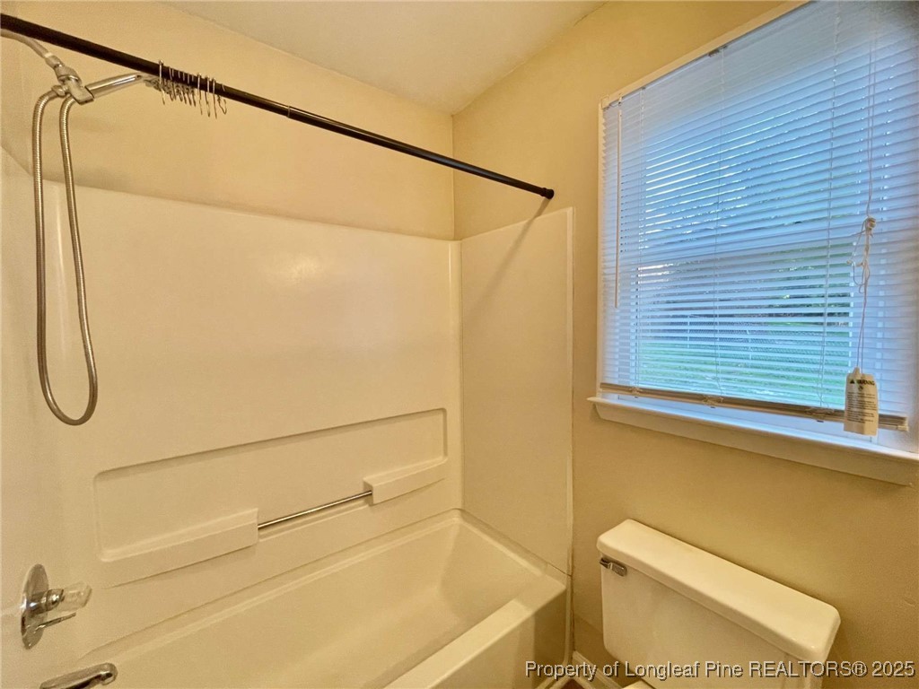 1505 Diamond Road Fayetteville, NC 28311 - Photo 6 of 21 a bathroom with a shower a toilet and sink