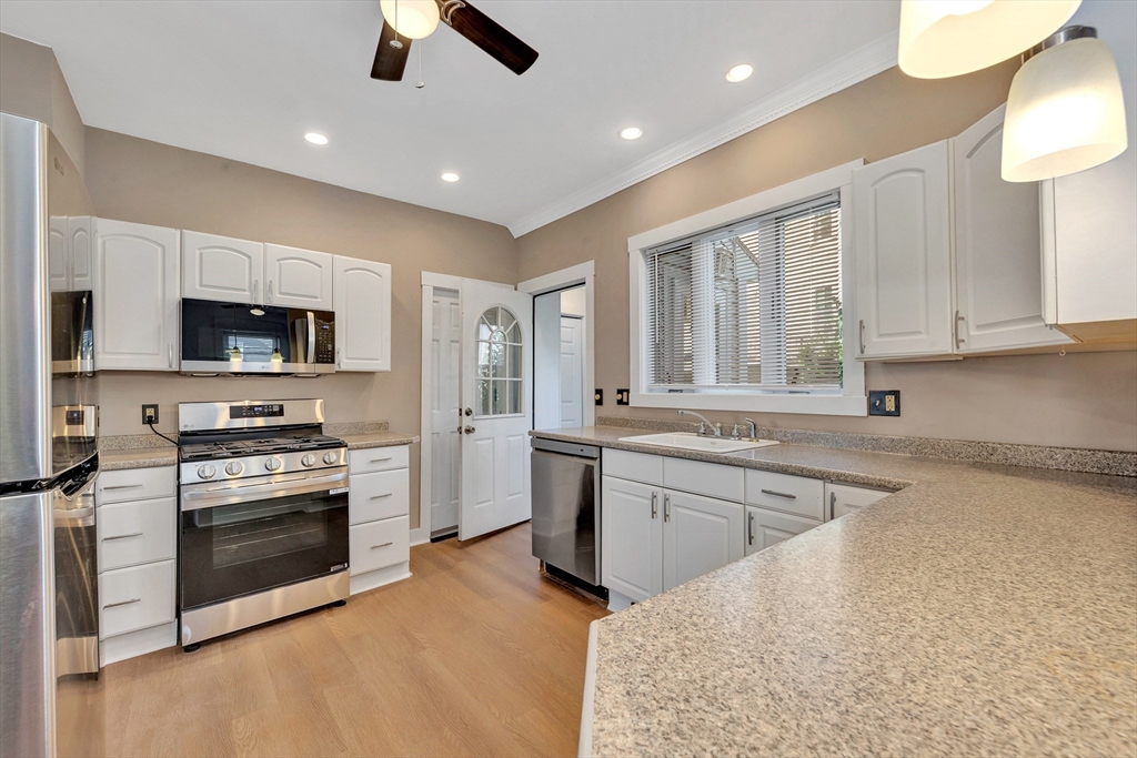 24 Taylor Street, Unit 1 Gloucester, MA 01930 - Photo 11 of 29 a kitchen with stainless steel appliances granite countertop a stove and a sink
