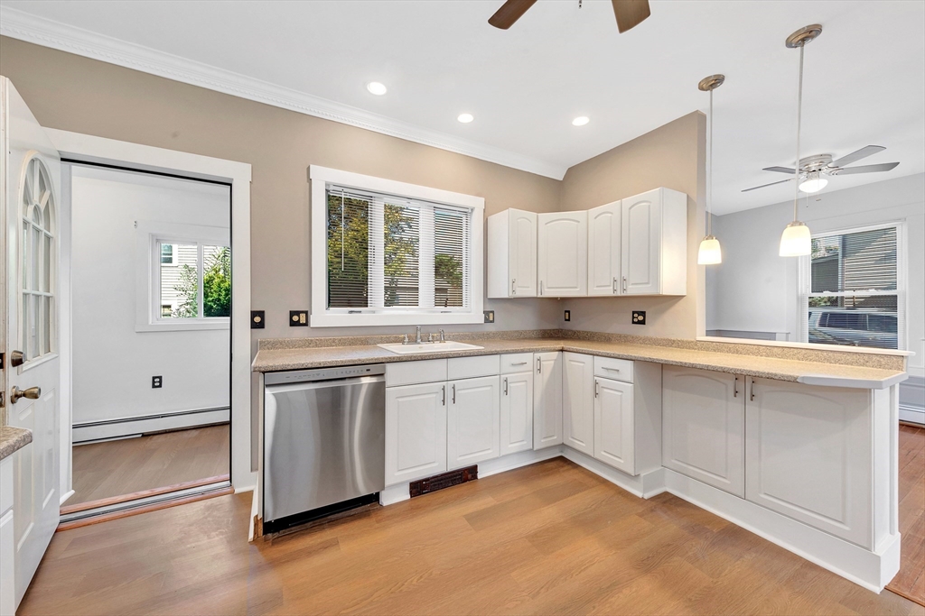24 Taylor Street, Unit 1 Gloucester, MA 01930 - Photo 12 of 29 a large white kitchen with a window