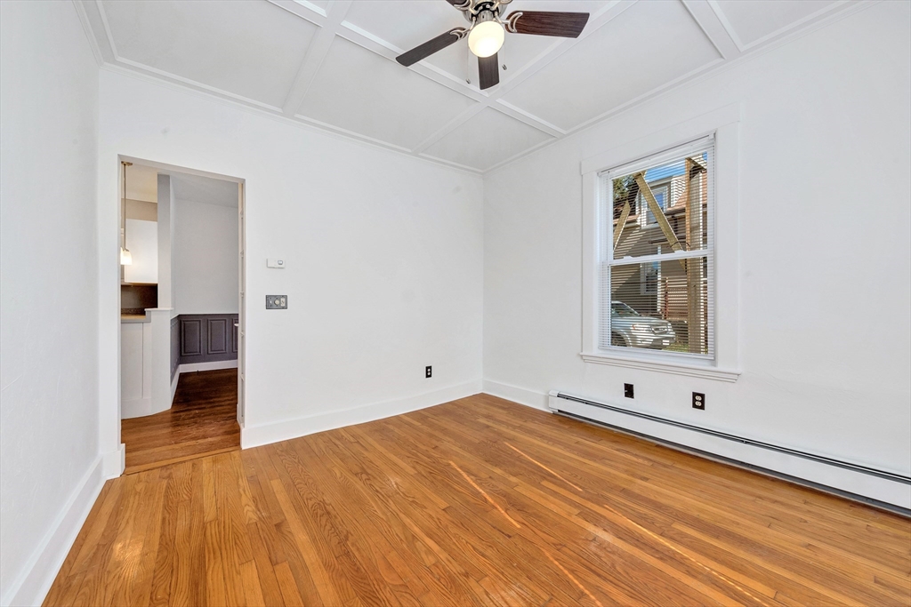 24 Taylor Street, Unit 1 Gloucester, MA 01930 - Photo 20 of 29 a view of an empty room with window and wooden floor