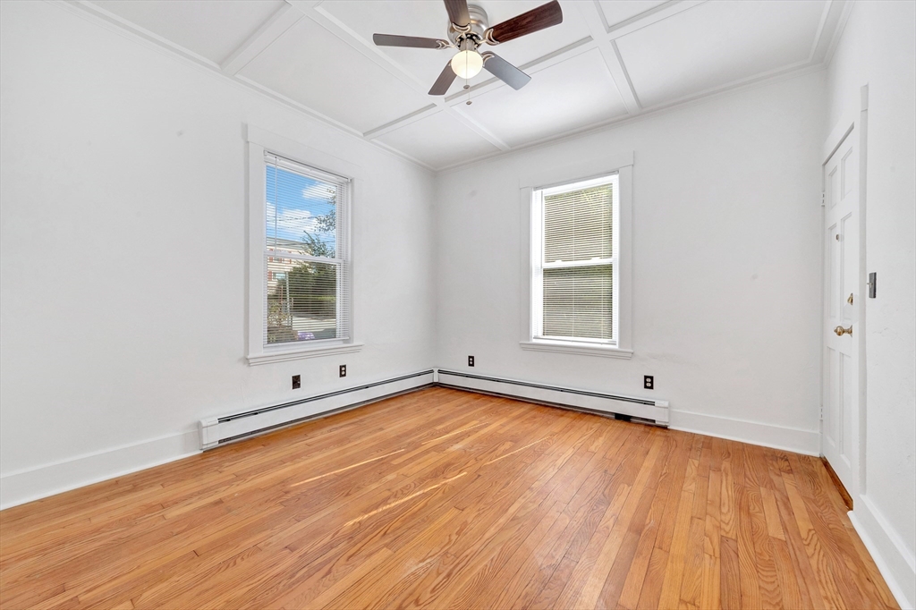 24 Taylor Street, Unit 1 Gloucester, MA 01930 - Photo 21 of 29 wooden floor in an empty room with a window