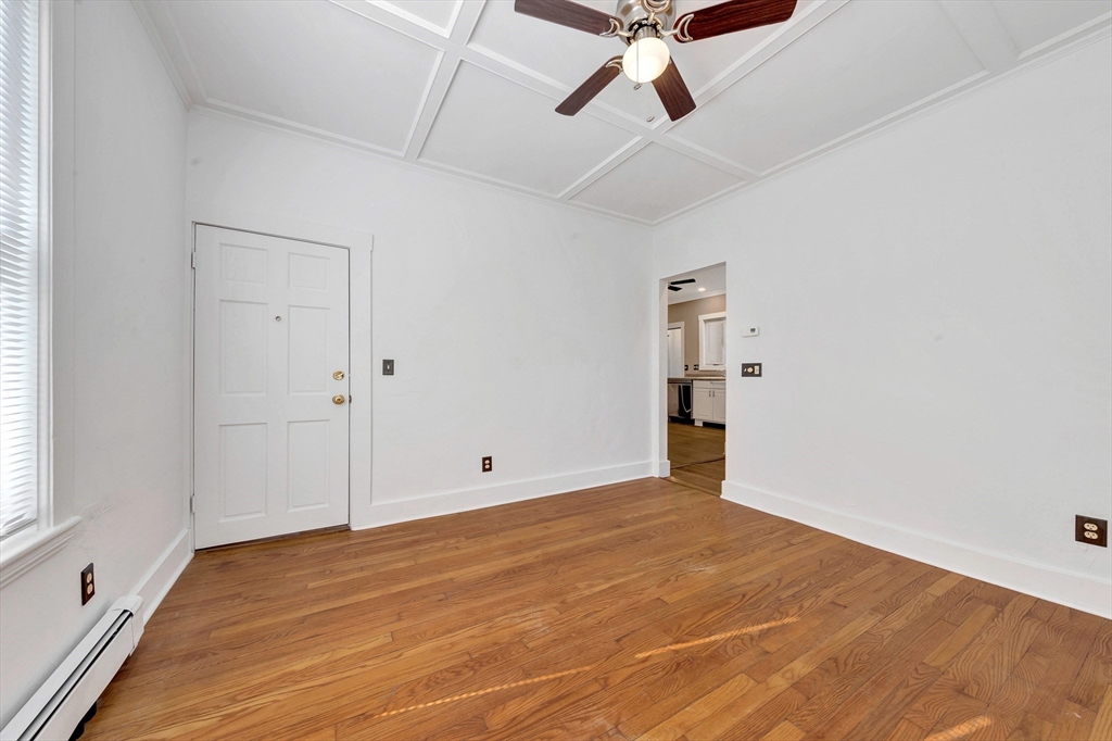 24 Taylor Street, Unit 1 Gloucester, MA 01930 - Photo 23 of 29 a view of an empty room with wooden floor and windows