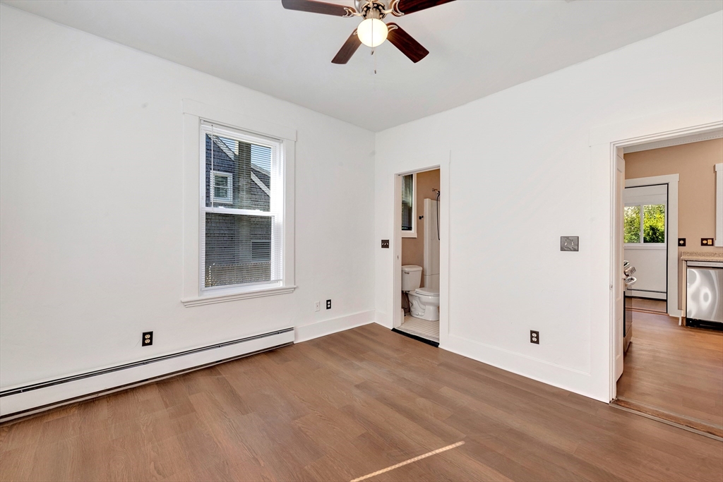 24 Taylor Street, Unit 1 Gloucester, MA 01930 - Photo 27 of 29 wooden floor in an empty room with a window