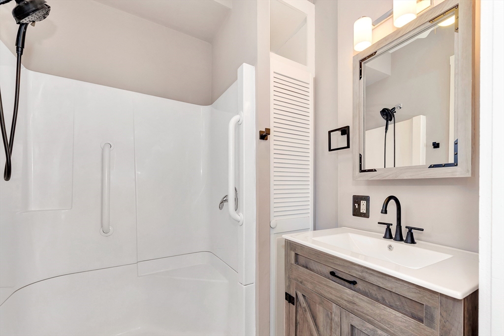 24 Taylor Street, Unit 1 Gloucester, MA 01930 - Photo 29 of 29 a bathroom with a sink and a mirror