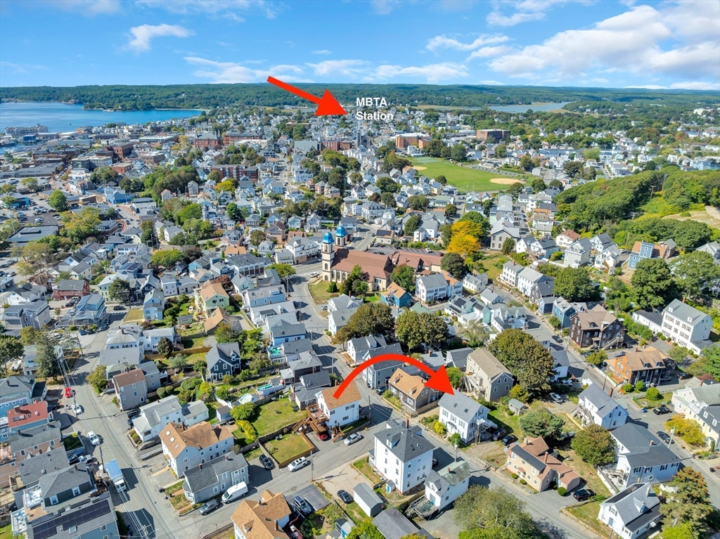 24 Taylor Street, Unit 1 Gloucester, MA 01930 - Photo 8 of 29 an aerial view of residential houses with outdoor space and swimming pool