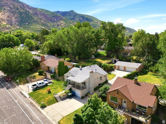 1341 29th Street Ogden, UT 84403 - Photo 37 of 37 Aerial perspective showcasing a light-colored home with a covered front porch and a detached three-car garage