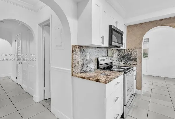 a kitchen with stainless steel appliances granite countertop a sink stove and cabinets
