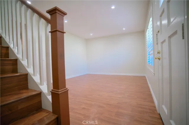 a view of an entryway with wooden floor