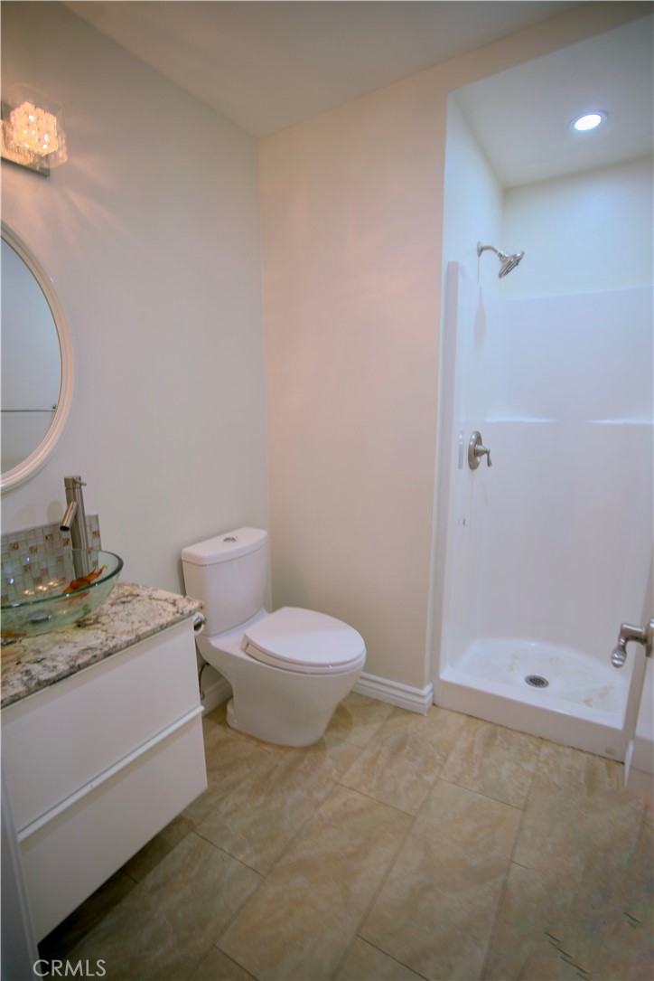 10 Raleigh Irvine, CA 92604 - Photo 16 of 28 a bathroom with a granite countertop sink and a mirror