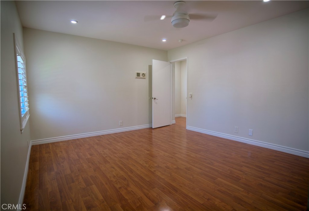 10 Raleigh Irvine, CA 92604 - Photo 6 of 28 an empty room with wooden floor and windows