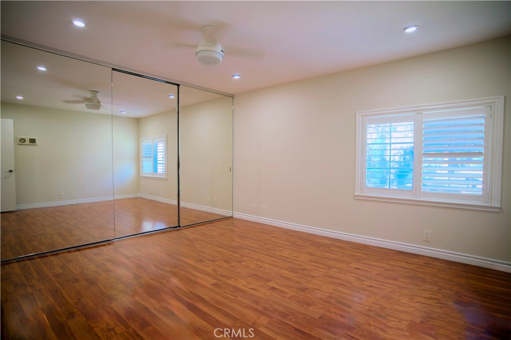 10 Raleigh Irvine, CA 92604 - Photo 7 of 28 an empty room with wooden floor and windows
