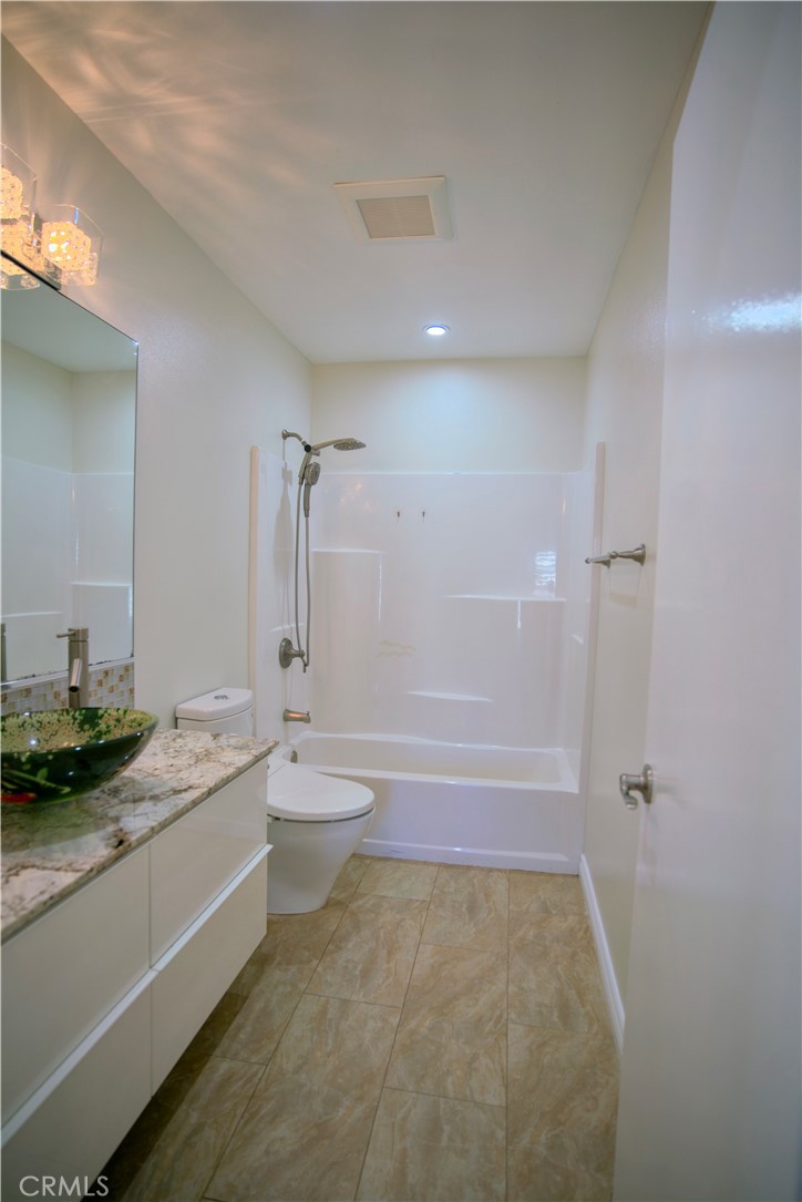 10 Raleigh Irvine, CA 92604 - Photo 8 of 28 a bathroom with a granite countertop sink a toilet and shower