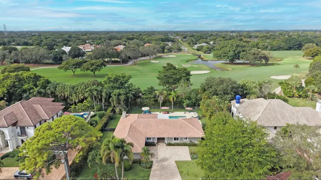 an aerial view of a house with garden space and ocean view