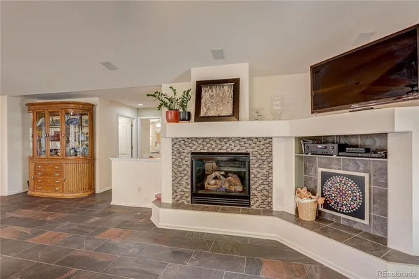 a living room with a fireplace and a flat screen tv
