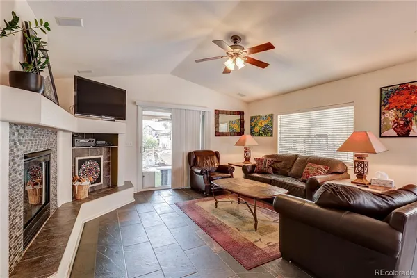 a living room with furniture and a fireplace