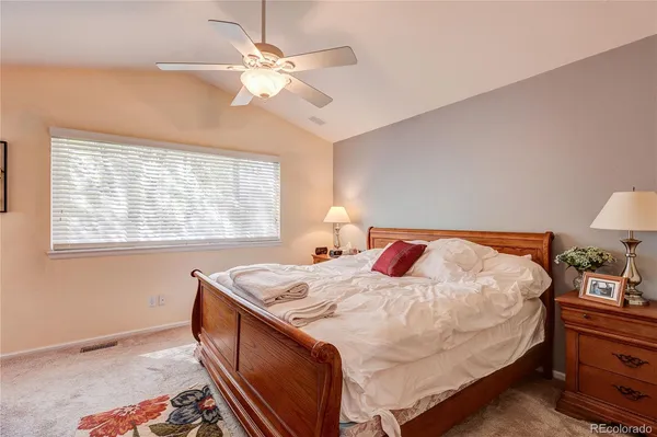 a bedroom with a bed and a dresser with the shoe rack