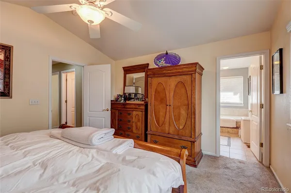 a bedroom with a bed and cabinets
