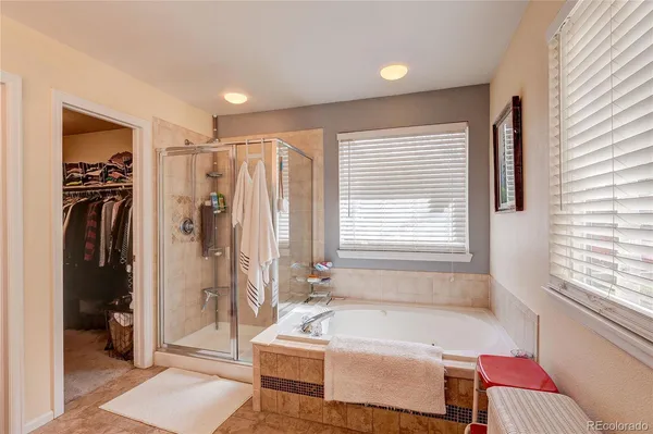 a spacious bathroom with a bathtub and a shower