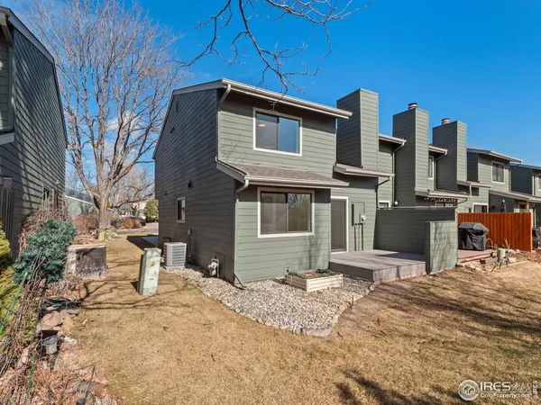 a backyard of a house with yard and outdoor seating