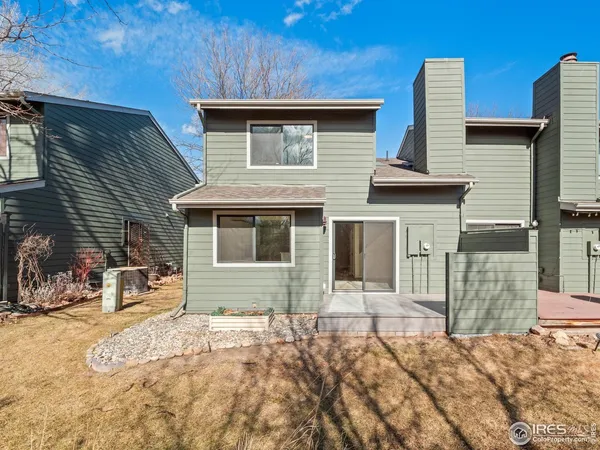 a backyard of a house with yard and outdoor seating