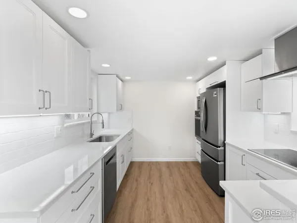 a kitchen with a sink stainless steel appliances and cabinets