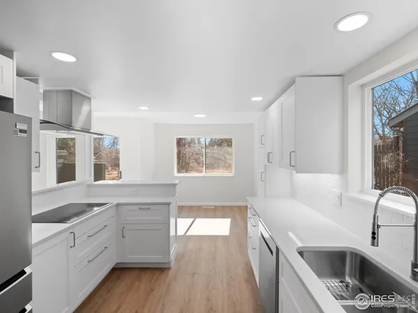 a spacious bathroom with stainless steel appliances double vanity granite and a sink