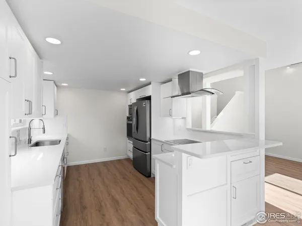 a kitchen with kitchen island a sink appliances and cabinets
