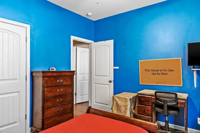 a room with a dresser and a flat screen tv