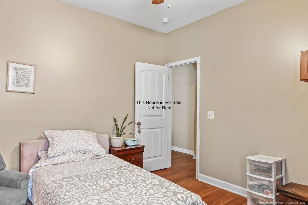 113 Meherrin Loop Raeford, NC 28376 - Photo 15 of 27 a bedroom with a bed and wooden floor